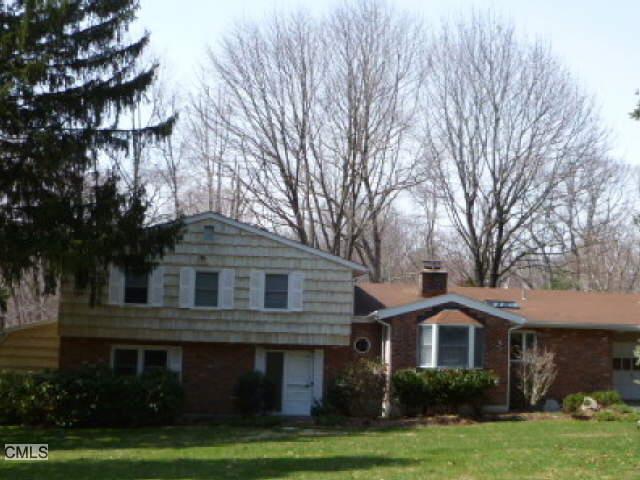 106 Russet Road Stamford, CT 06903 - Photo 1 of 1 a front view of a house with a garden and trees