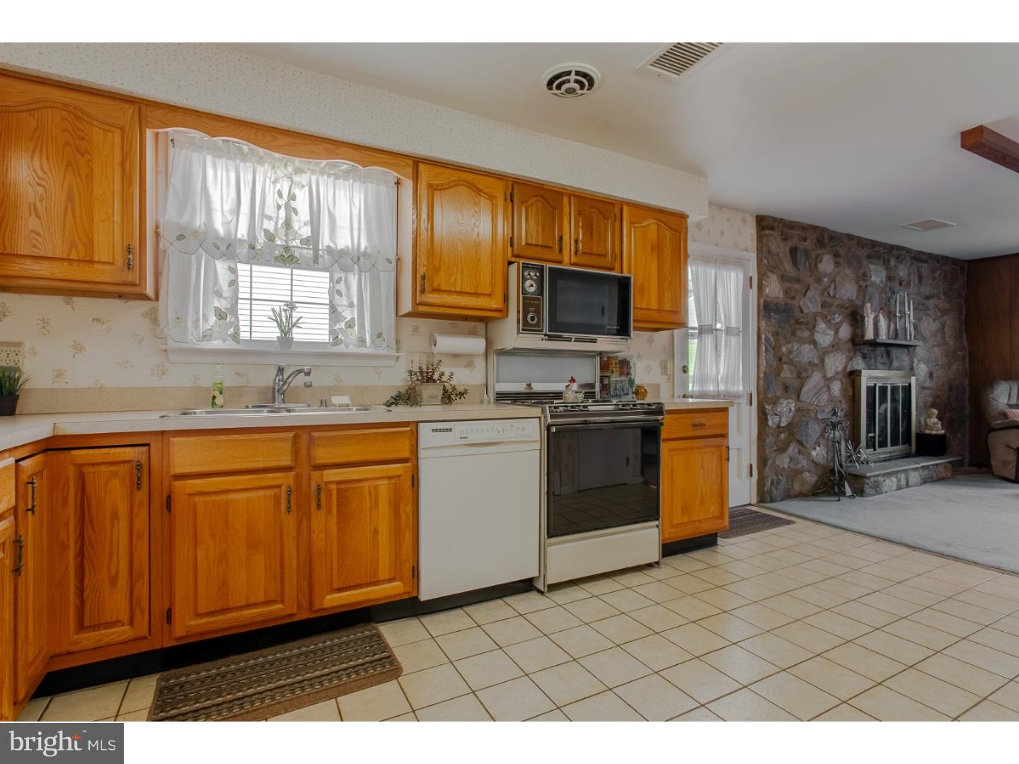 743 West Rolling Road Springfield, PA 19064 - Photo 10 of 19 a kitchen with stainless steel appliances granite countertop a stove a sink and a microwave