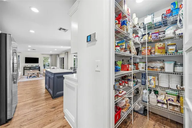 a kitchen with stainless steel appliances a sink stove refrigerator and cabinets