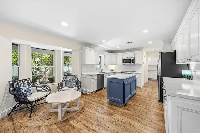 a kitchen with a sink refrigerator and microwave