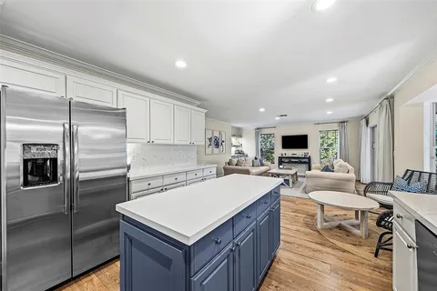 a large kitchen with kitchen island a sink a counter space and stainless steel appliances