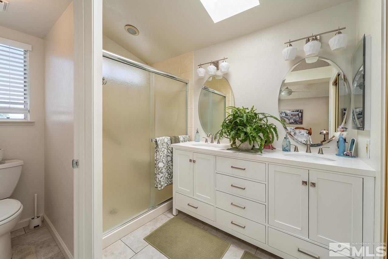 1263 Starview Circle Reno, NV 89523 - Photo 25 of 38 a bathroom with a granite countertop sink toilet and mirror