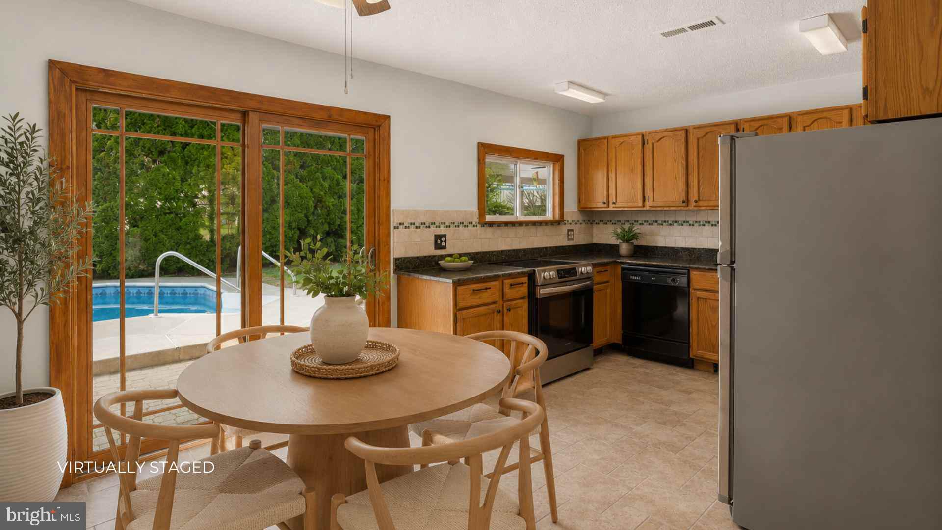 23 Cotton Road Levittown, PA 19057 - Photo 8 of 36 a kitchen with stainless steel appliances granite countertop a stove a refrigerator a dining table and chairs