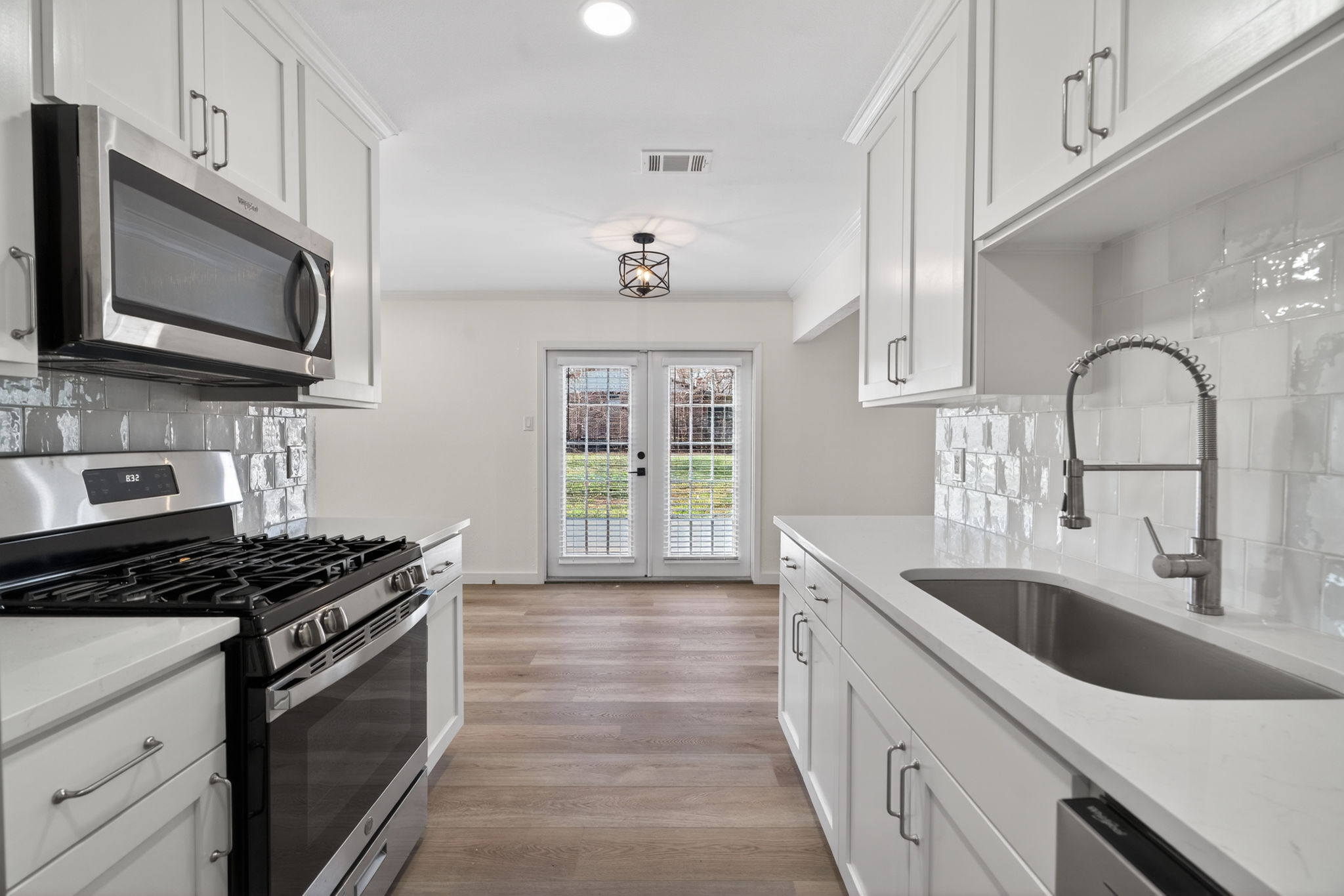 8400 Seminary Ridge Drive Austin, TX 78745 - Photo 14 of 37 Kitchen featuring stainless steel appliances, decorative backsplash, french doors, and white cabinets