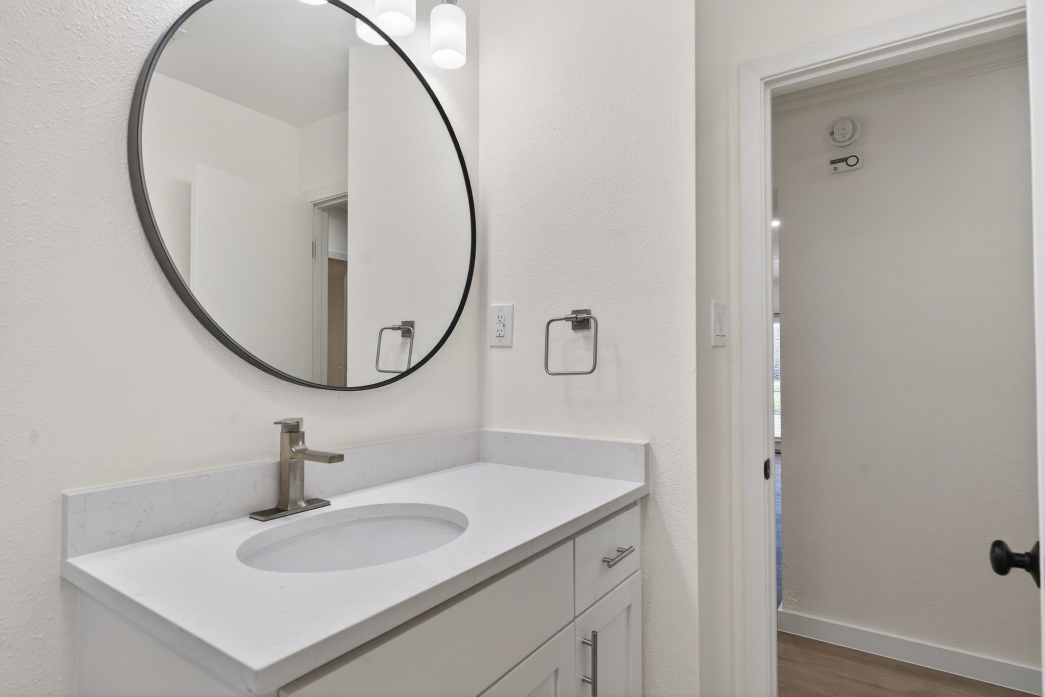 8400 Seminary Ridge Drive Austin, TX 78745 - Photo 19 of 37 Bathroom with vanity, a textured wall, and wood finished floors