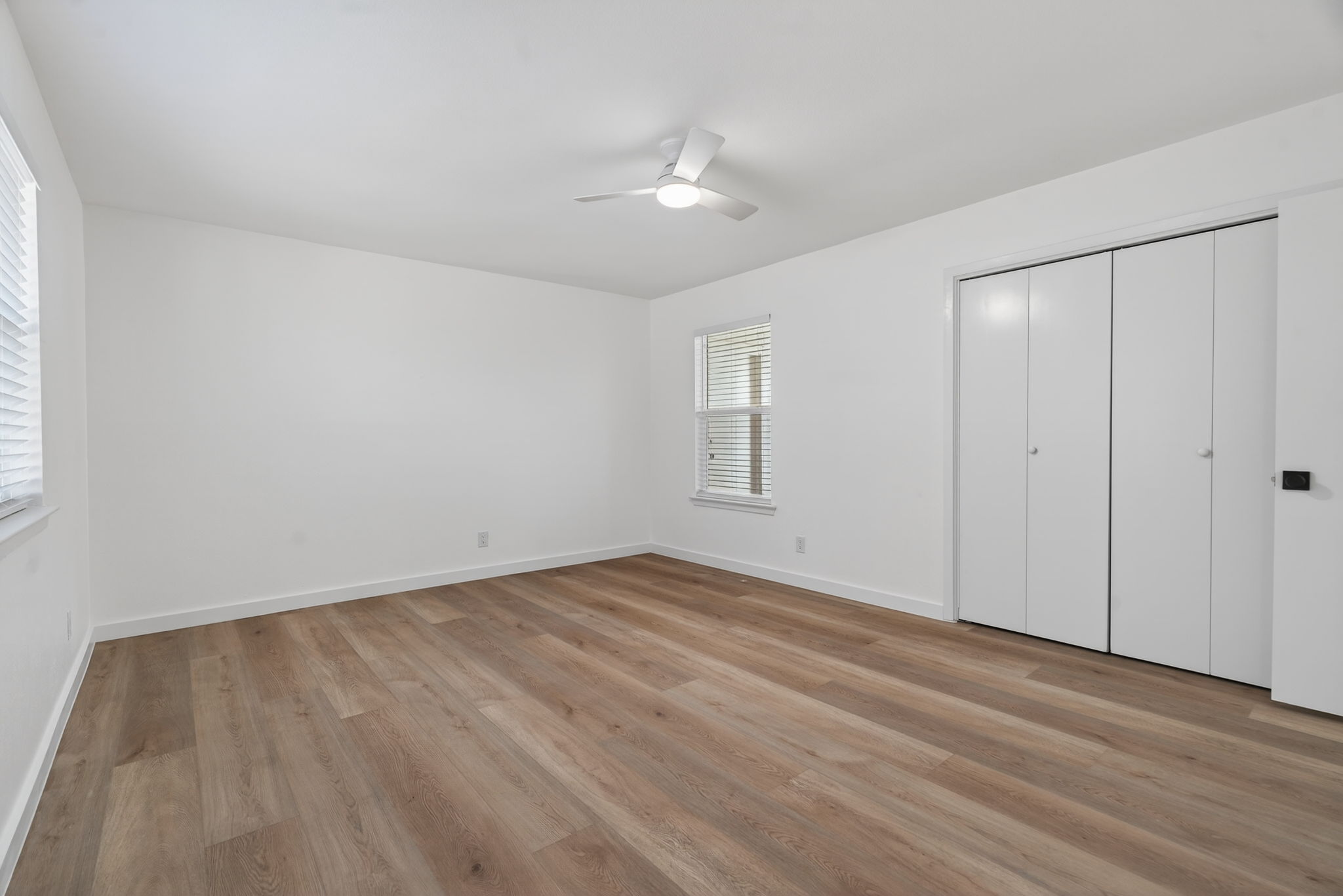 8400 Seminary Ridge Drive Austin, TX 78745 - Photo 24 of 37 Unfurnished bedroom with light wood finished floors, a ceiling fan, and a closet