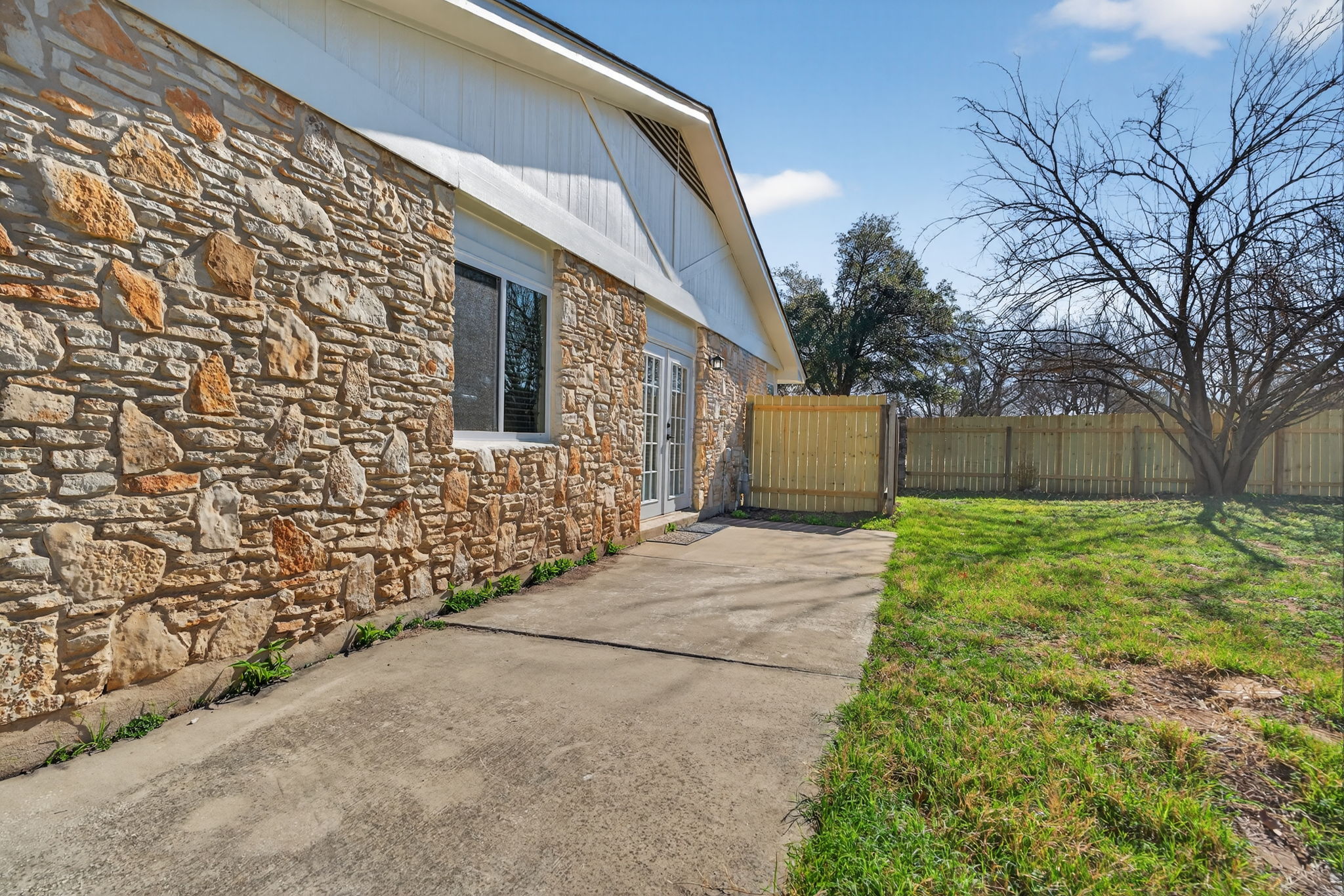 8400 Seminary Ridge Drive Austin, TX 78745 - Photo 26 of 37 View of property exterior featuring stone siding and a gate