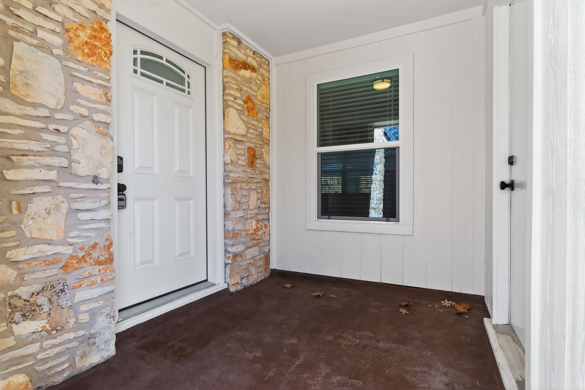 8400 Seminary Ridge Drive Austin, TX 78745 - Photo 4 of 37 Doorway to property with stone siding and a patio