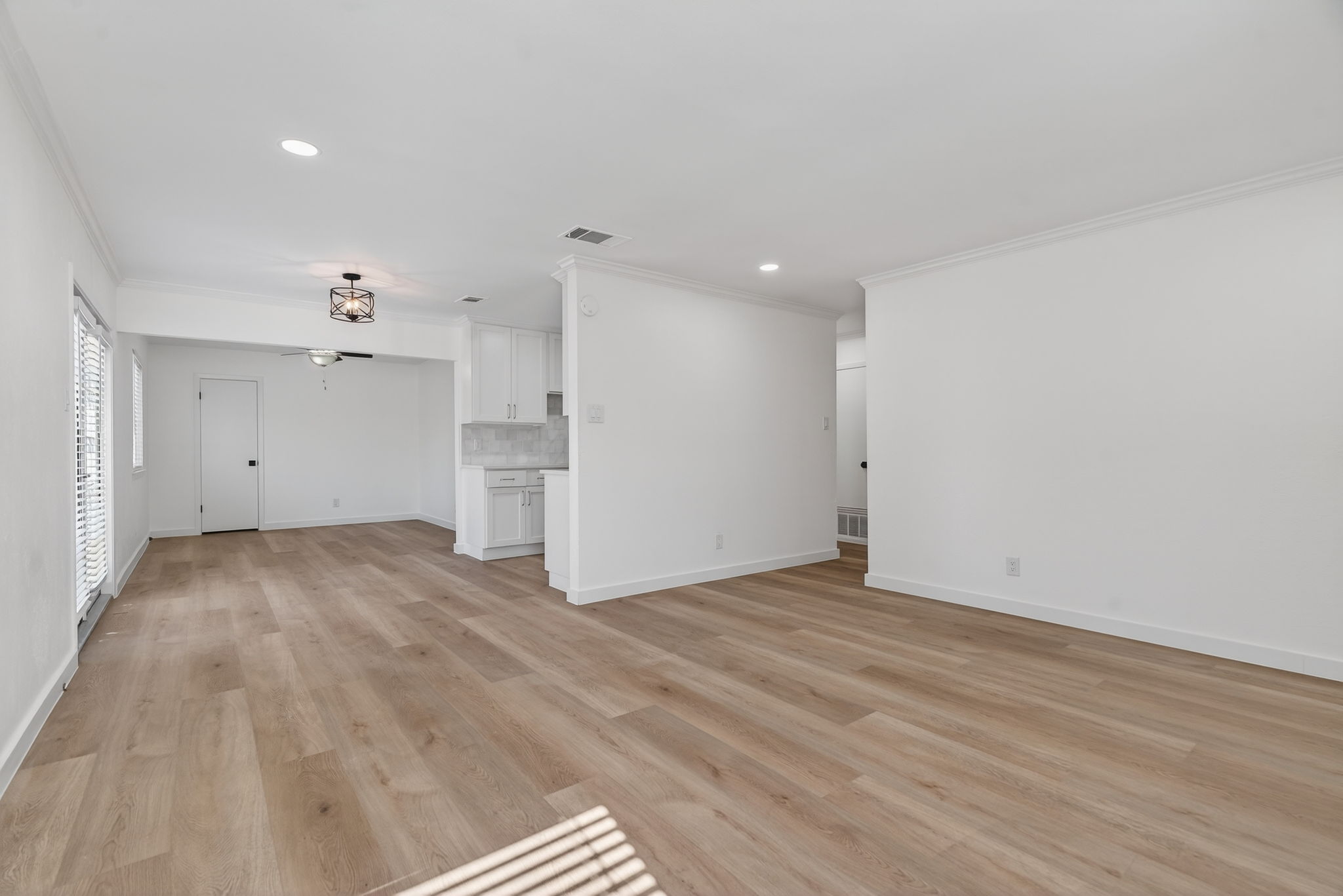 8400 Seminary Ridge Drive Austin, TX 78745 - Photo 9 of 37 Unfurnished living room with crown molding, recessed lighting, and light wood finished floors
