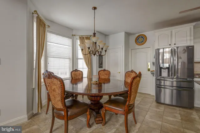 a dining room with furniture and window