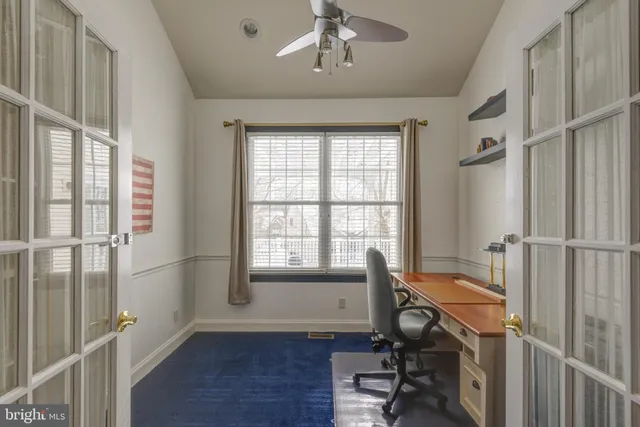 a view of a room with wooden floor and windows