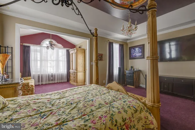 a bed room with a bed and a large window