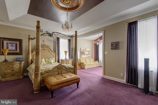 a living room with furniture a chandelier and a flat screen tv