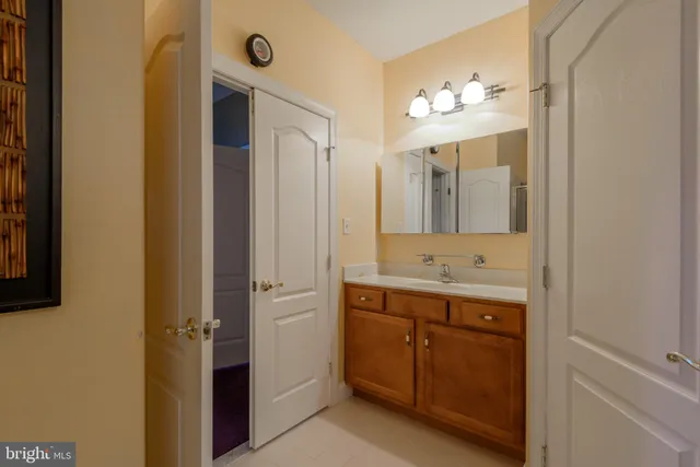 a bathroom with a double vanity sink and a mirror