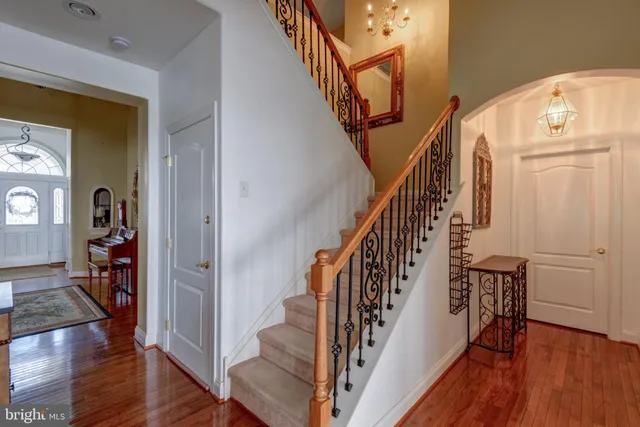 a view of entryway with wooden floor and stairs