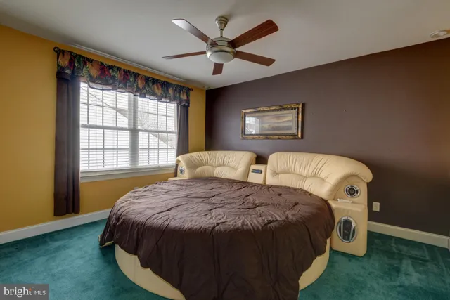 a spacious bedroom with a bed and a large window