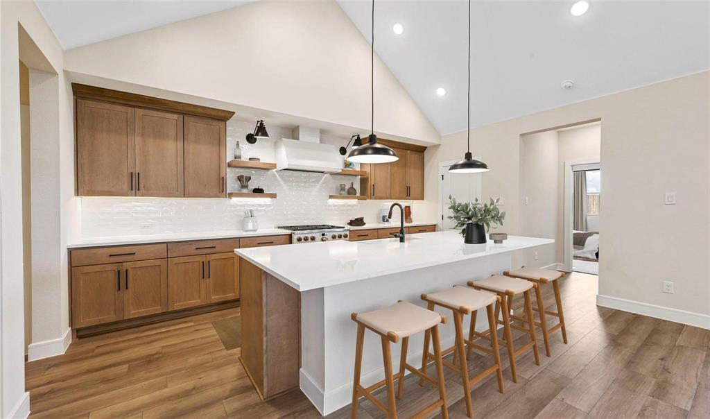 1527 Buckthorn Road Fate, TX 75087 - Photo 12 of 36 a kitchen with white cabinets and white appliances