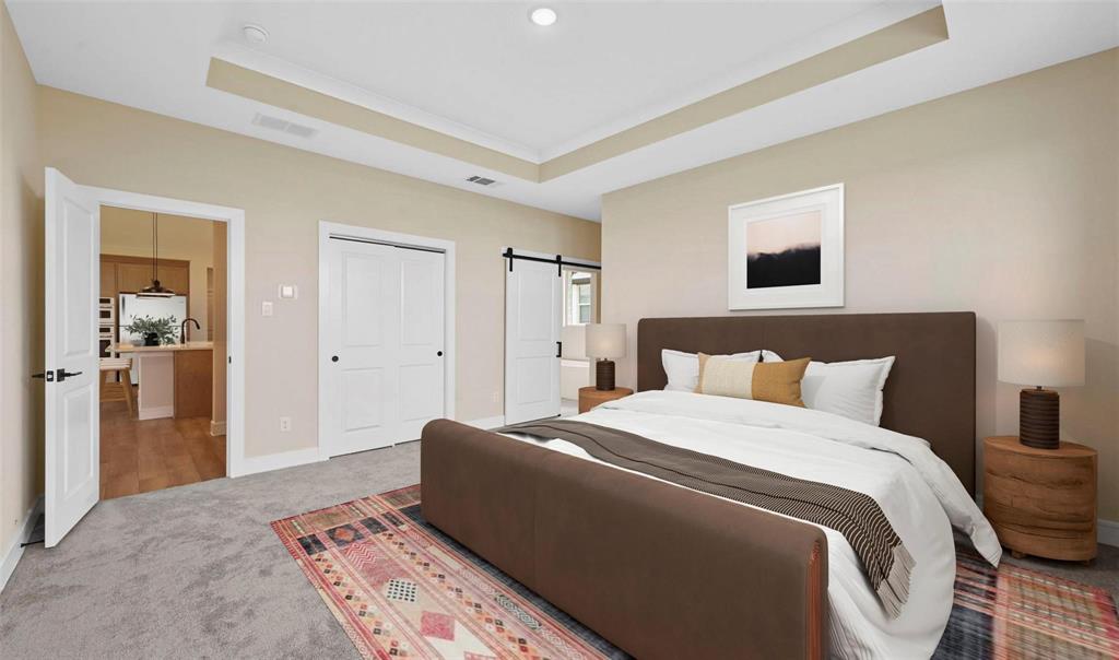 1527 Buckthorn Road Fate, TX 75087 - Photo 15 of 36 a bedroom with a large bed and a chandelier