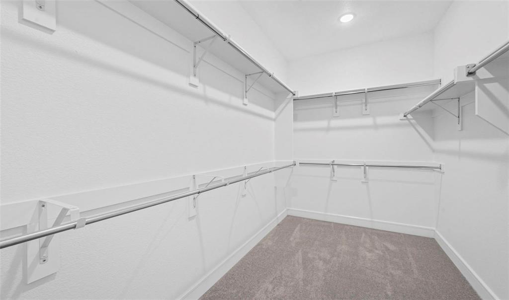 1527 Buckthorn Road Fate, TX 75087 - Photo 18 of 36 a view of a room with racks on the wall