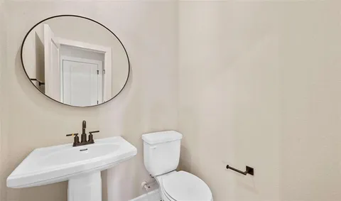 a bedroom with a bed a rug and potted plant