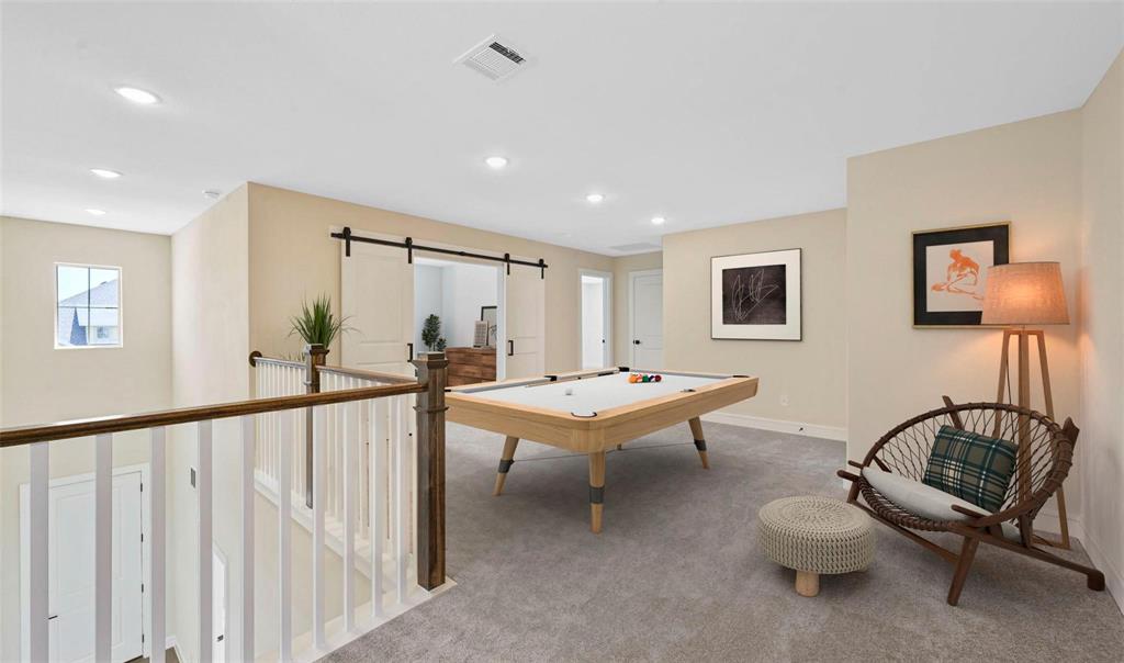 1527 Buckthorn Road Fate, TX 75087 - Photo 25 of 36 a view of a livingroom with furniture and a couch