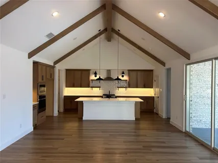 wooden floor in an empty room with a window and fireplace