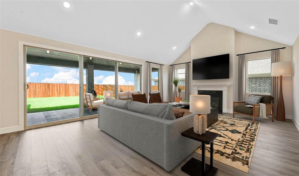 1527 Buckthorn Road Fate, TX 75087 - Photo 7 of 36 a living room with fireplace furniture and a flat screen tv