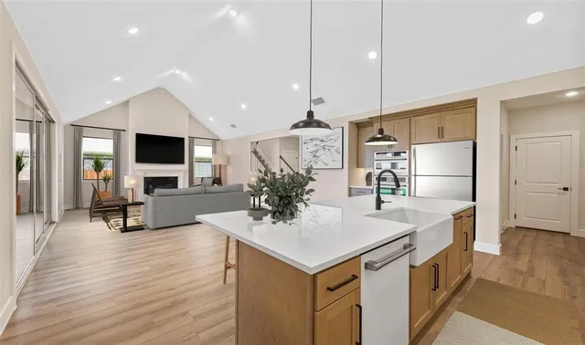a kitchen with stainless steel appliances a sink stove and refrigerator