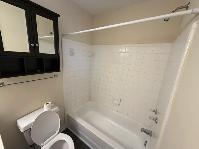 a bathroom with a toilet a sink and bathtub