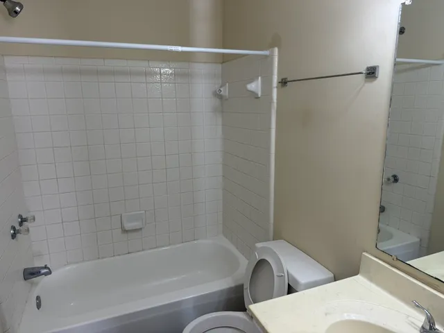 a bathroom with a bathtub and shower