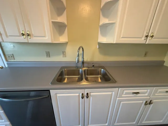 a kitchen with stainless steel appliances granite countertop a sink and a stove