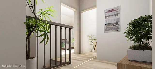 a view of a hallway with wooden floor and a potted plant