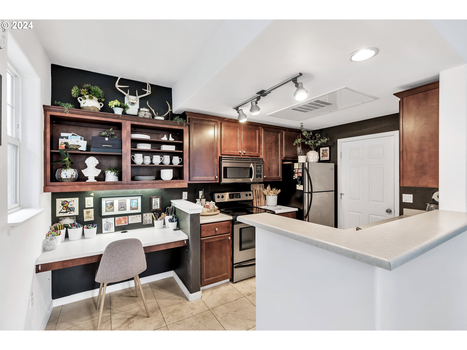 925 Springtree Lane West Linn, OR 97068 - Photo 11 of 24 a kitchen with stainless steel appliances kitchen island granite countertop a table chairs and a refrigerator