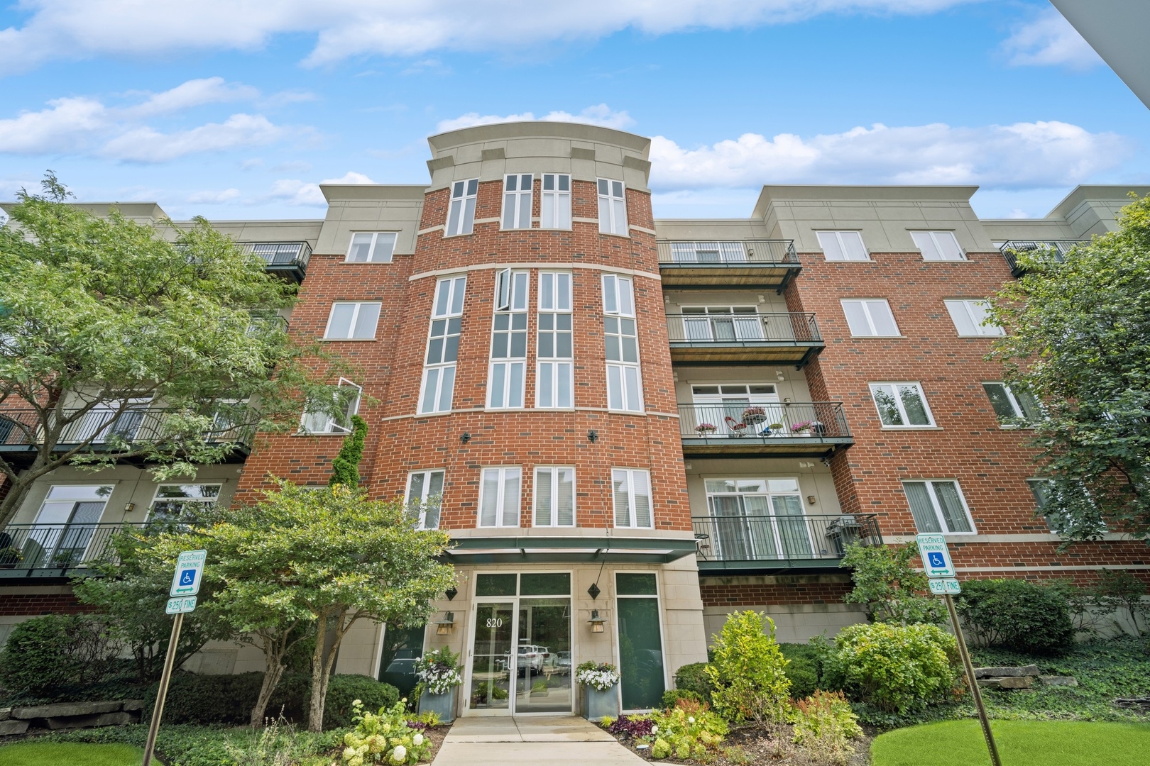 a front view of a residential apartment building with a yard