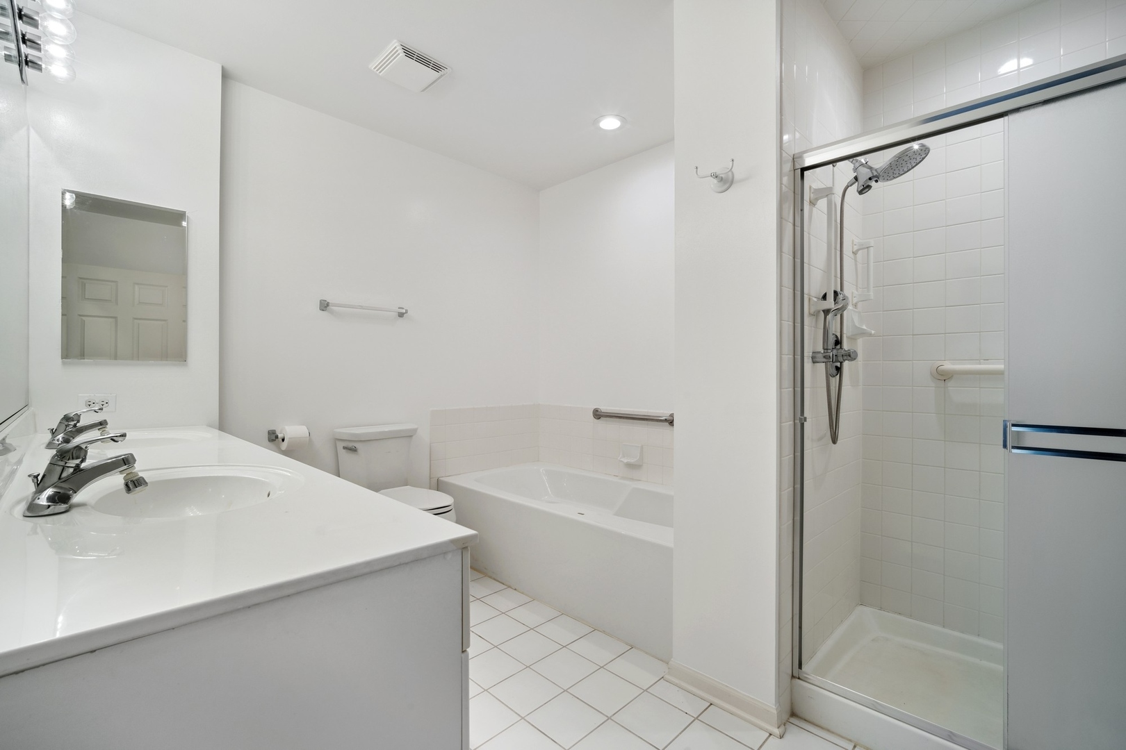 820 Weidner Road, Unit 304 Buffalo Grove, IL 60089 - Photo 11 of 18 a bathroom with a tub sink shower and a mirror