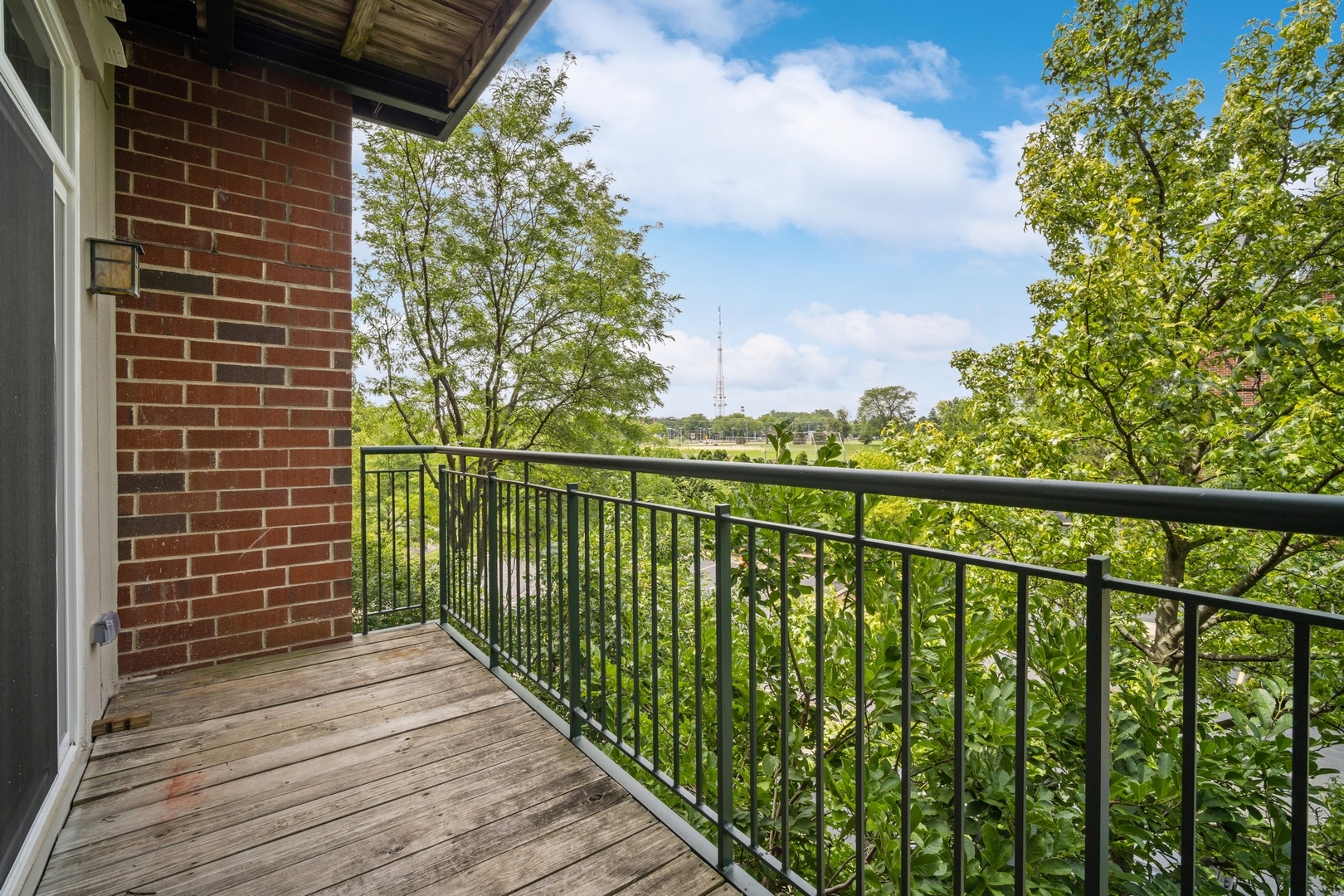 820 Weidner Road, Unit 304 Buffalo Grove, IL 60089 - Photo 17 of 18 a view of a balcony with wooden floor and fence