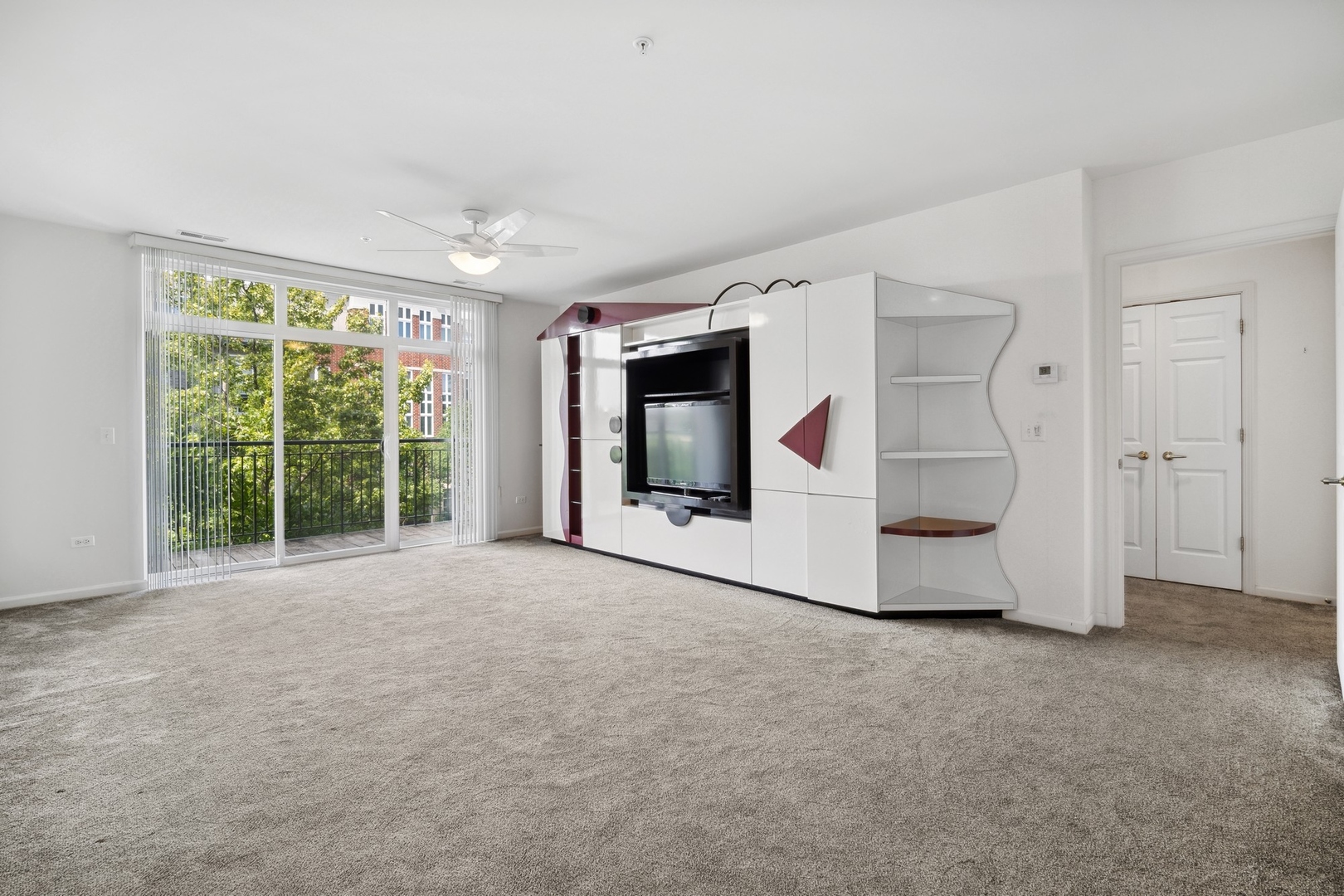 820 Weidner Road, Unit 304 Buffalo Grove, IL 60089 - Photo 5 of 18 a view of an empty room with a fireplace and a large window