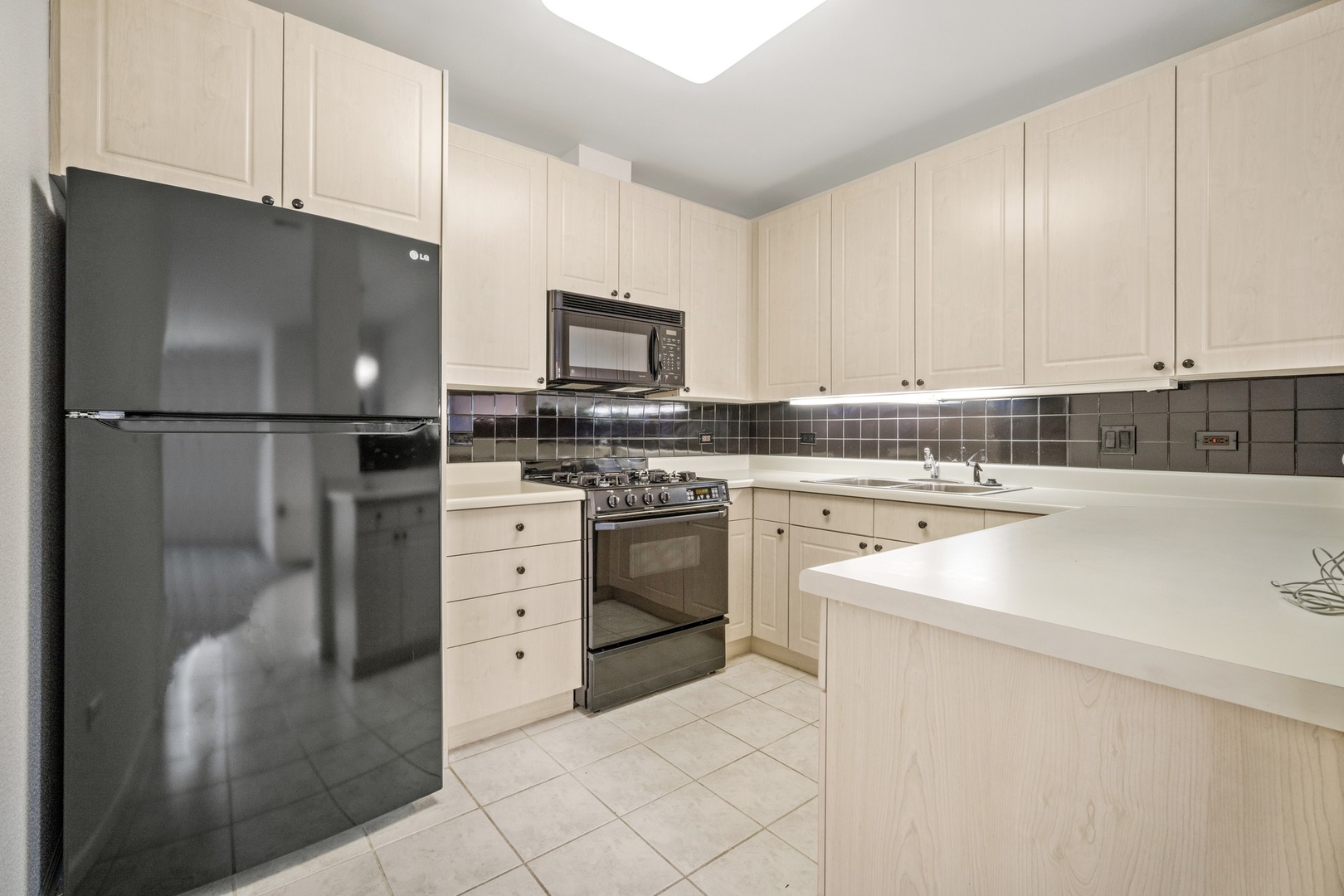 820 Weidner Road, Unit 304 Buffalo Grove, IL 60089 - Photo 8 of 18 a kitchen with white cabinets and white appliances