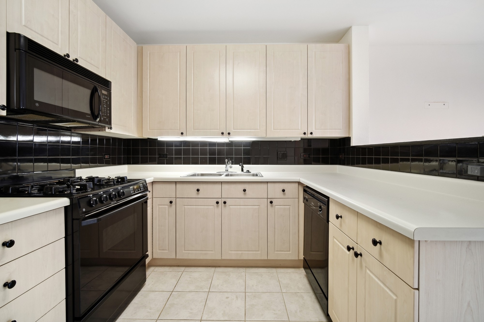 820 Weidner Road, Unit 304 Buffalo Grove, IL 60089 - Photo 9 of 18 a kitchen with a sink stove and cabinets