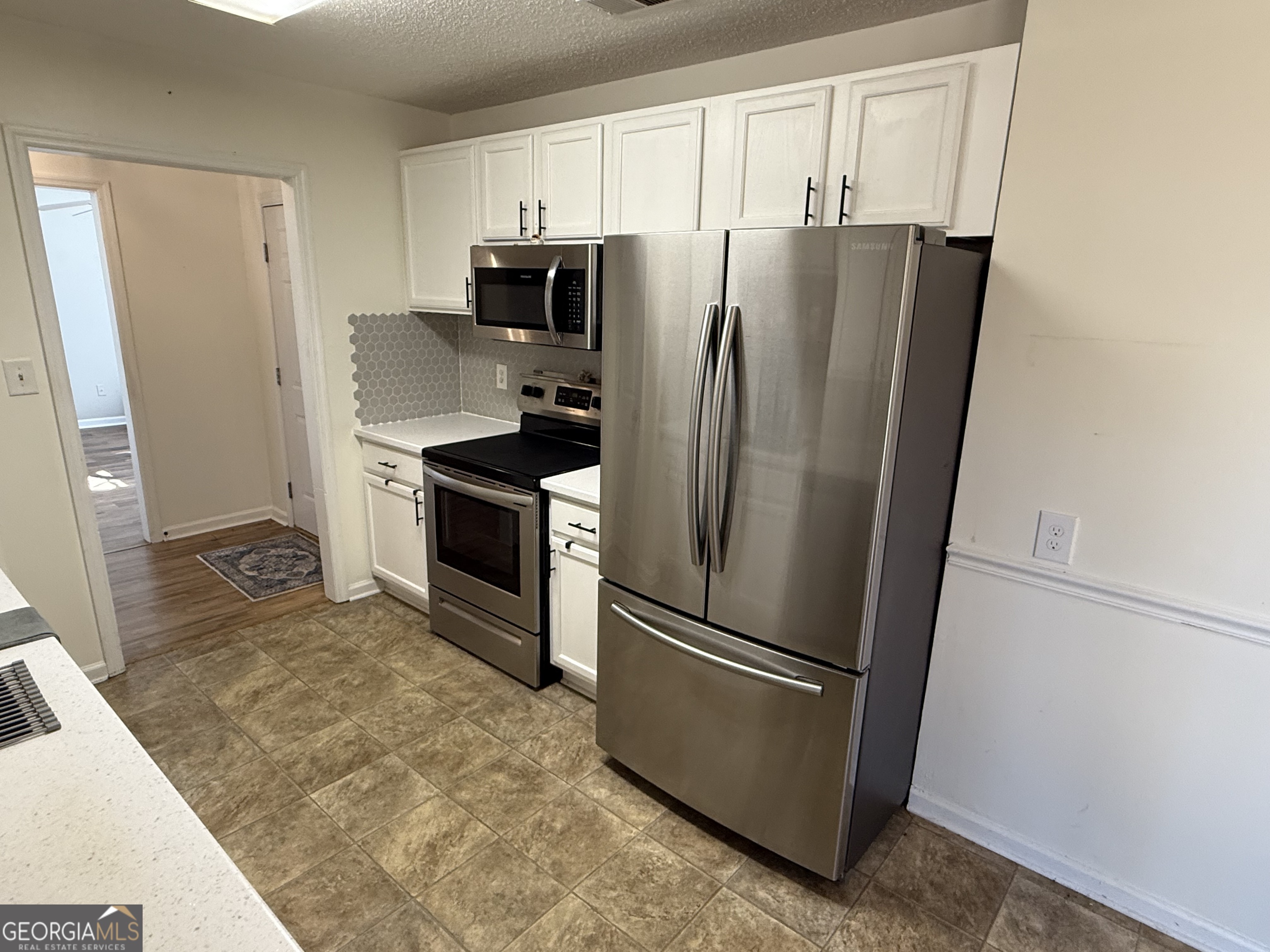 109 Layla Court Athens, GA 30605 - Photo 20 of 32 a metallic refrigerator freezer sitting in a kitchen