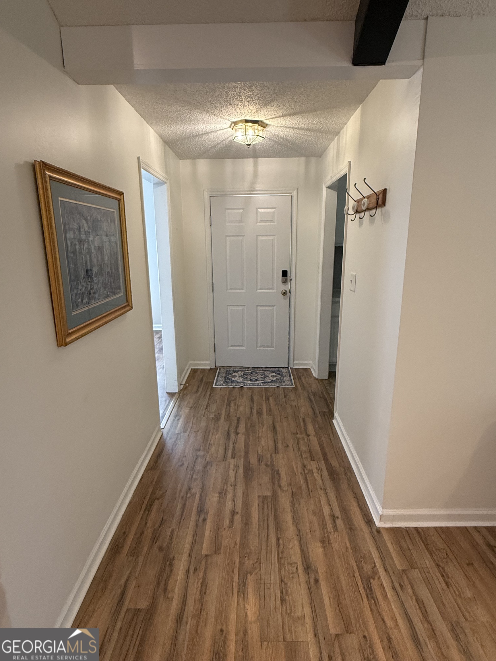 109 Layla Court Athens, GA 30605 - Photo 6 of 32 a view of a hallway with wooden floor and a ceiling fan