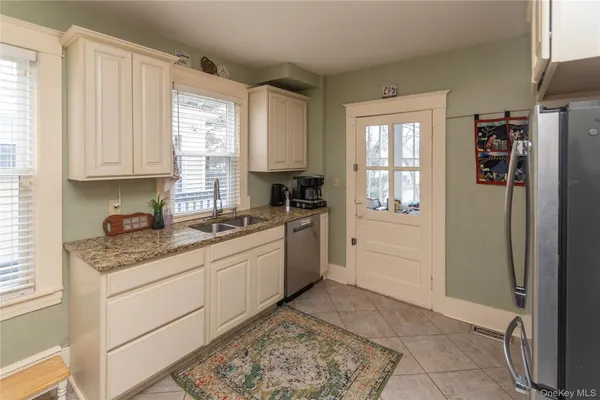 a kitchen with stainless steel appliances granite countertop a refrigerator and a stove top oven