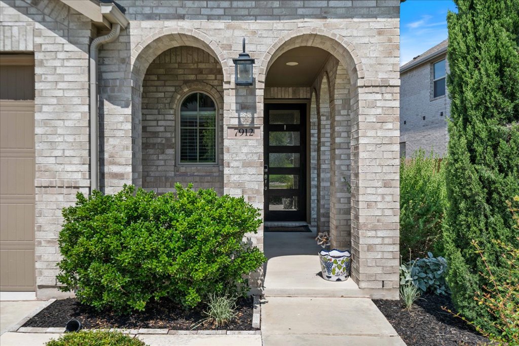 7912 Prairie Rye Drive Lago Vista, TX 78645 - Photo 9 of 37 Charming front entry with elegant brick arches