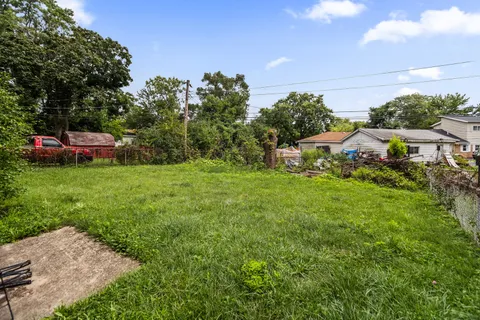 a backyard of a house with table and chairs