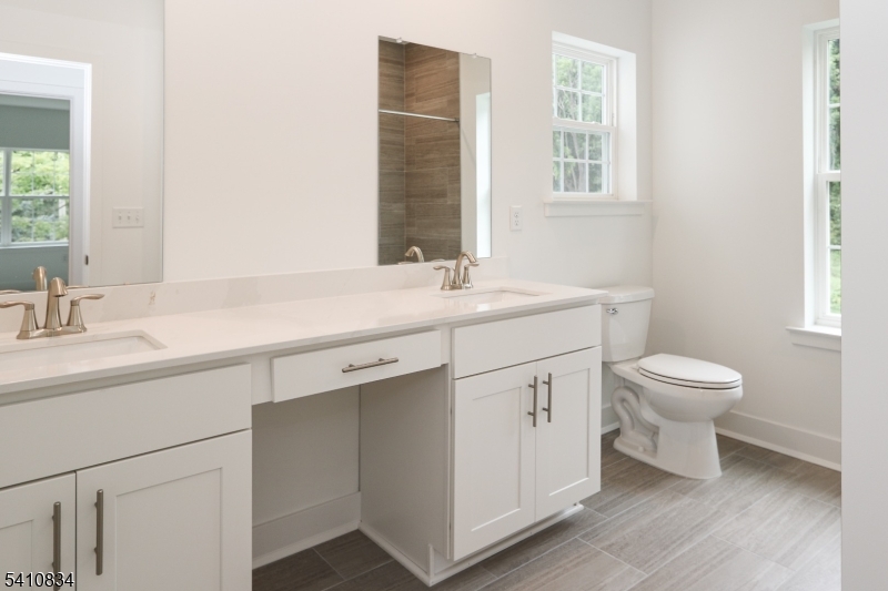 71 Veterans Way Morris Plains, NJ 07950 - Photo 20 of 23 a bathroom with a toilet sink and mirror