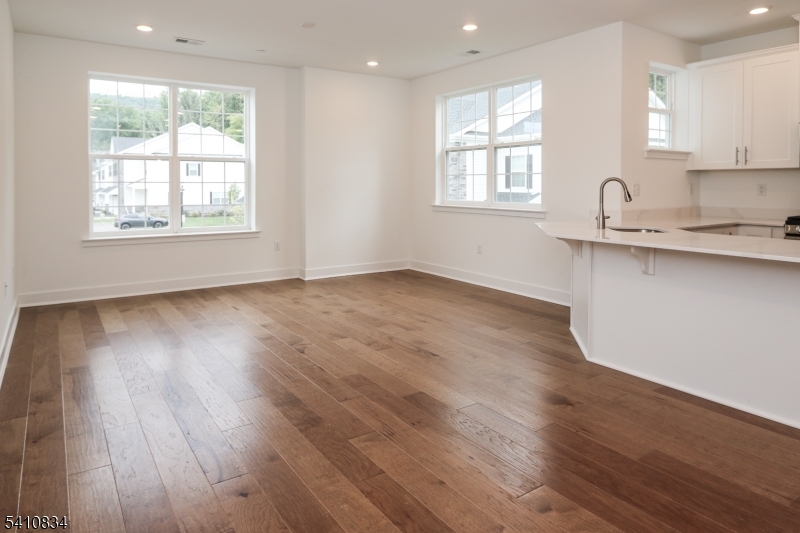 71 Veterans Way Morris Plains, NJ 07950 - Photo 3 of 23 a kitchen with granite countertop wooden floors a sink cabinets and wooden floor