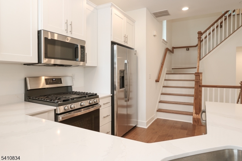 71 Veterans Way Morris Plains, NJ 07950 - Photo 7 of 23 a kitchen with stainless steel appliances granite countertop a stove and a microwave