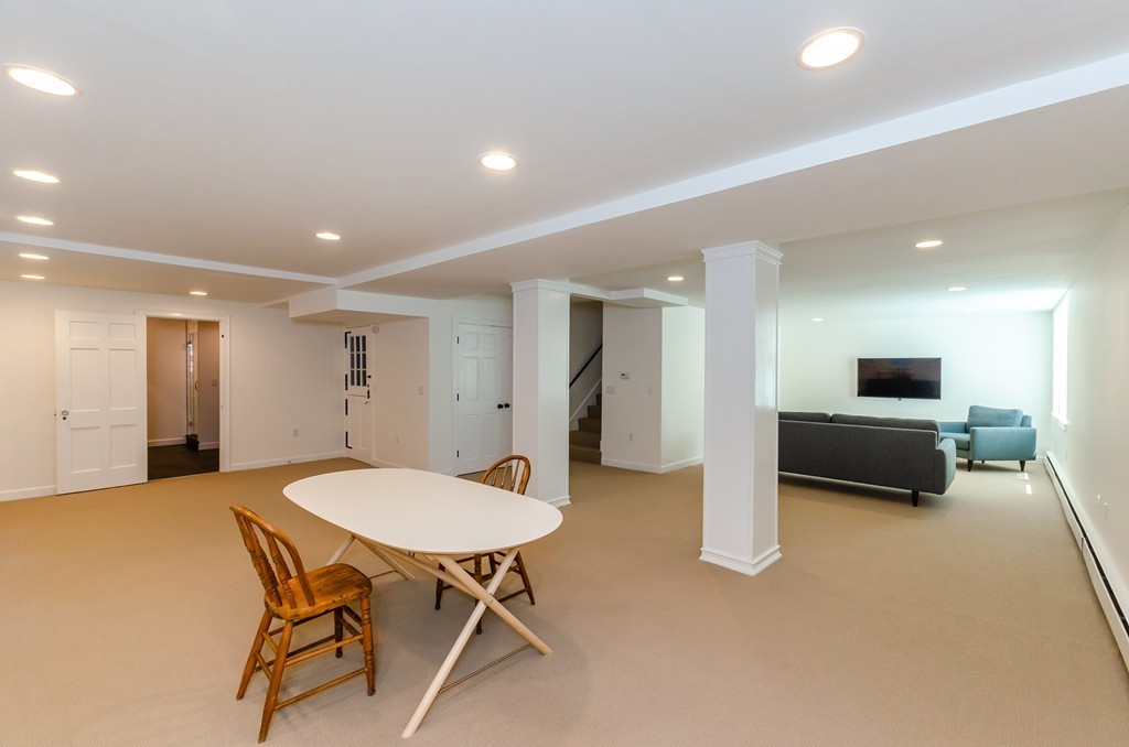 2 Old Colony Road Weston, MA 02493 - Photo 21 of 25 a living room with furniture a flat screen tv and a table