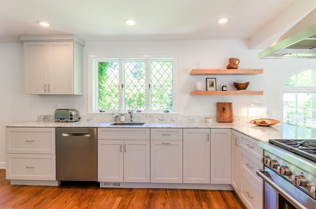 2 Old Colony Road Weston, MA 02493 - Photo 6 of 25 a kitchen with kitchen island granite countertop white cabinets and white appliances
