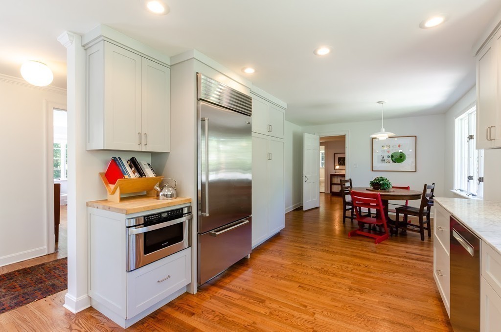 2 Old Colony Road Weston, MA 02493 - Photo 7 of 25 a kitchen with stainless steel appliances wooden floor and dining table